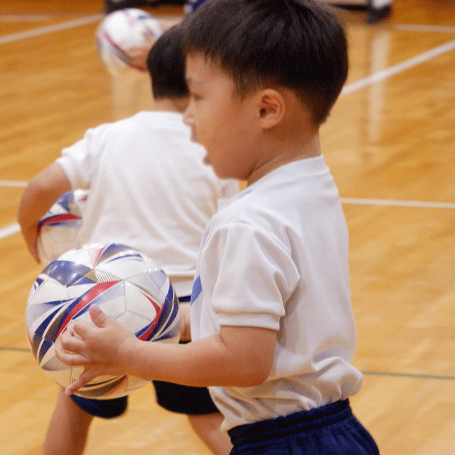 サッカーボールを手に持った子供